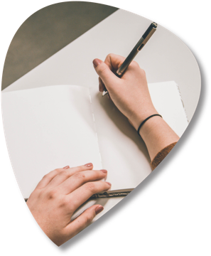 A person writing in a notebook