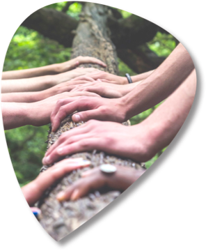 Many hands resting together on a log