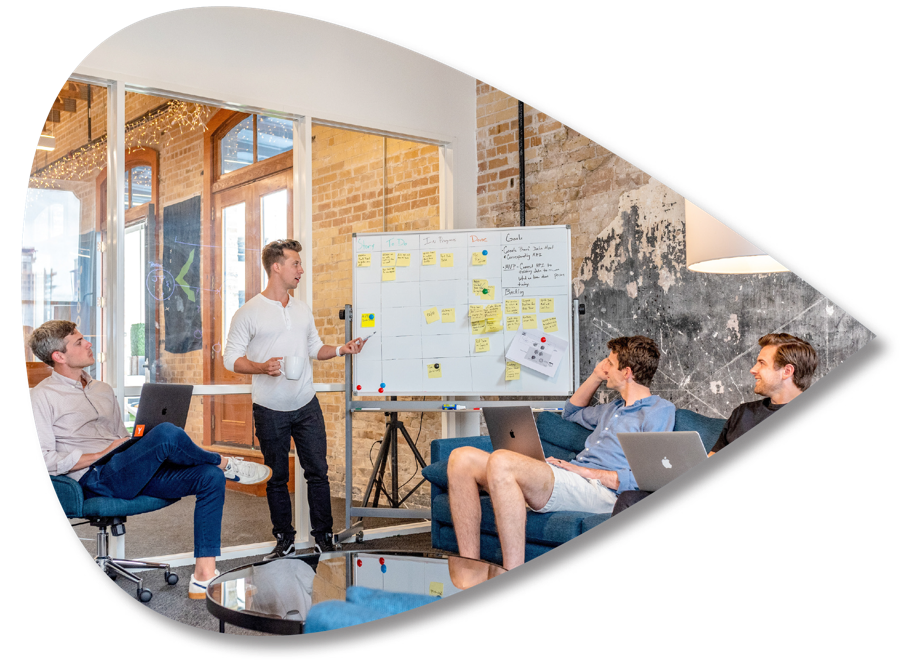 A team working through ideas on a whiteboard
